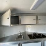 A small kitchen with a sink and a refrigerator.