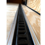 The side of a trailer with a Floor E Trac metal railing.