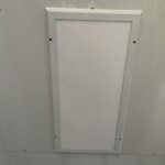A white panel on the ceiling of a room.