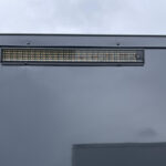 A black trailer with a led light on the side.