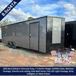 Grey enclosed double-axle trailer on gravel with black diamond-plate front; listing text notes 8.5x24TA and features (charcoal gray) and LED lighting package.
