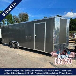 Charcoal gray enclosed trailer with dual axles and a side entry door, diamond-plate front, parked on a lot; sale banner and specs indicating 7' interior height and LED lighting.