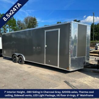 Enclosed 8.5x24 tandem-axle cargo trailer in charcoal gray with side entry door and diamond-plate front.