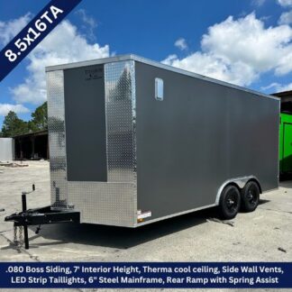 Enclosed cargo trailer, tandem axle, 8.5x16TA, dark grey siding with diamond-plate front and rear ramp parked on a lot.