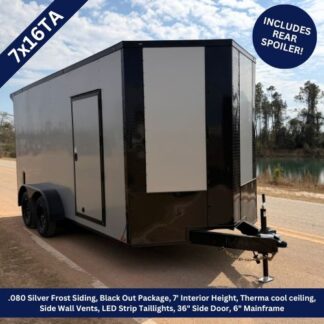 Cargo trailer with silver frost siding and black trim on a road, dual axles, and a front hitch jack visible.