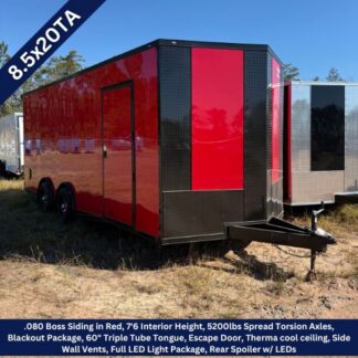 Red enclosed cargo trailer with black diamond-plate nose, side entry door, tandem wheels, on a dirt lot under a blue sky.