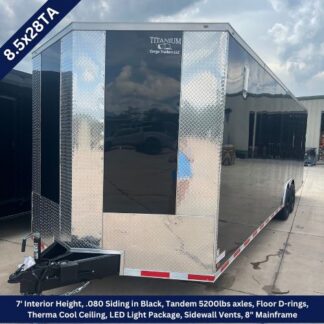 Black enclosed cargo trailer with diamond-plate exterior, tandem axles, and a front hitch, parked outdoors