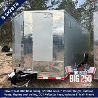 Enclosed silver cargo trailer with diamond-plate panels, tandem axles, and a front hitch on a dirt lot; sale graphic visible in corner.