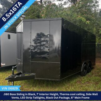 Black enclosed cargo trailer with diamond-plate front and dual axles, parked on grass; in-stock banner shows 8.5x16TA and 7' interior height with LED tail lights.