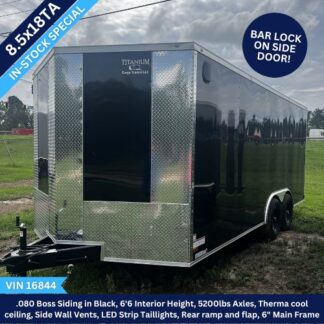 Black enclosed cargo trailer with diamond plate front and twin axles; label indicates 8.5x18 in-stock special, tandem wheels on a grassy lot under a cloudy sky. Includes bar-lock side door and rear ramp/door. VIN 16844 shown.