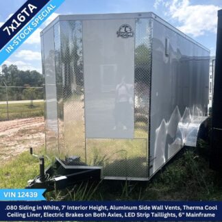 Enclosed silver cargo trailer with diamond-plate accents and a hitch, labeled TY16TA In-Stock Special, VIN 12439, in a grassy lot.
